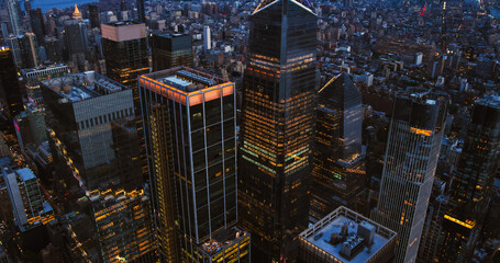 Aerial Photo of the 30 Hudson Yards Skyscraper at Night with Lights Turned On in the Building. Evening Helicopter Panorama Around the Modern Office Tower in Manhattan, New York City