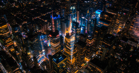 New York Concrete Jungle at Night. Aerial Photo from a Helicopter Tour Around the Center of the Big Apple. Scenes with Times Square District with Crowds of Tourists Enjoying Manhattan Nightlife - Powered by Adobe
