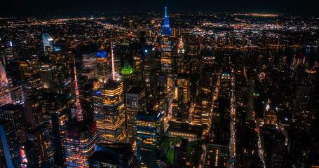 New York City Aerial Skyline with Historic and Modern Manhattan Skyscrapers and Residential Buildings at Night. Scenic Helicopter View of Popular Tourist and Business Attractions in the Dark