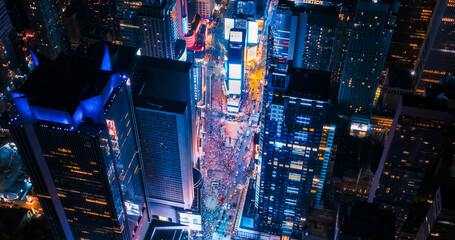 New York Concrete Jungle at Night. Aerial Shot from a Helicopter Tour Around Manhattan. Scenes with Modern Skyscraper Blocking the View on Crowded Times Square Area with Tourists - obrazy, fototapety, plakaty