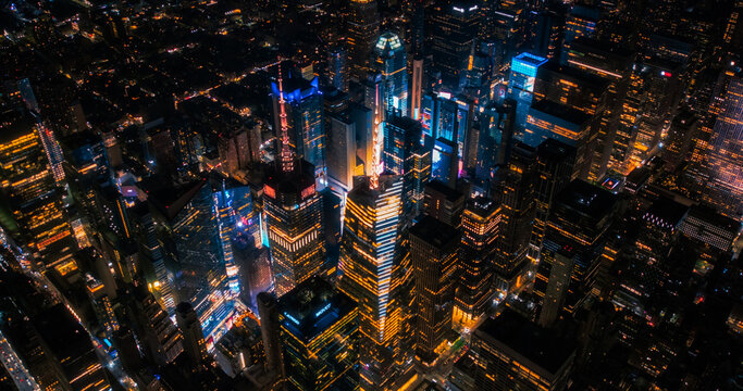 New York Concrete Jungle at Night. Aerial Photo from a Helicopter Tour Around the Center of the Big Apple. Scenes with Times Square District with Crowds of Tourists Enjoying Manhattan Nightlife