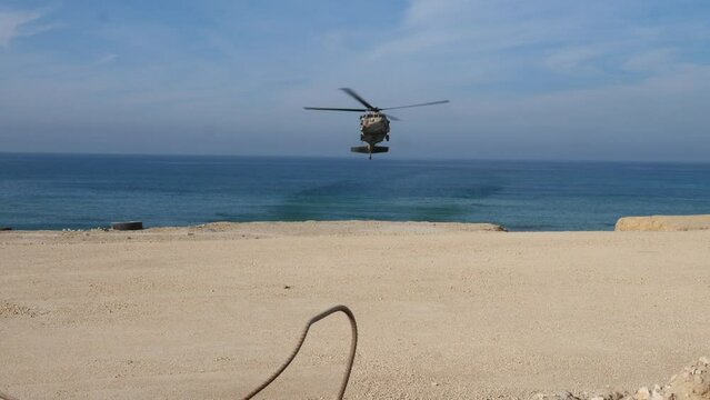 An IAF UH-60 Blackhawk hovering over Mediterranean sea before landing in Gaza