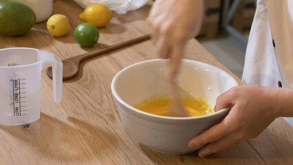 The cook mix egg yolks with sugar for dessert