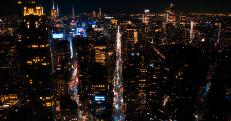 Scenic Aerial New York City View of Downtown Manhattan Architecture. Panoramic Night Shot of the Business District from a Helicopter. Cityscape with Office Buildings and Busy Traffic on Streets
