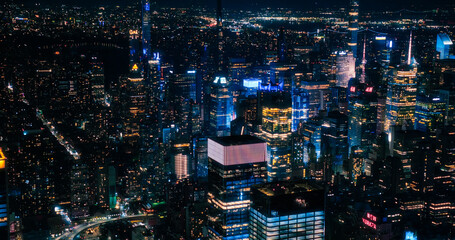 Scenic Aerial New York City View of Downtown Manhattan Architecture. Panoramic Shot of the Business District from a Helicopter. Cityscape with Buildings with Lights in Offices at Night