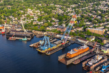 Aerial View with a Dry Dock Repair Area. Panorama of the Area from a Helicopter, Showing Residential and Industrial Buildings. Harbour Area with Ship and Loading Equipment