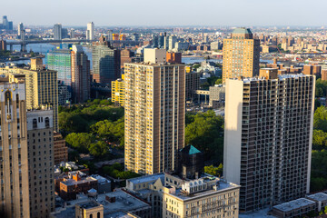 Fototapeta na wymiar New York Cityscape with Residential Neighbourhoods. Aerial Photo of Housing Complexes from a Helicopter. Panoramic View of a Big Modern City