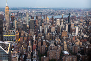 Beautiful Cinematic Aerial Sunset Photo of New York City Skyscrapers and Busy City Streets with Car Traffic. Panoramic Helicopter View of Lower Manhattan Office Buildings