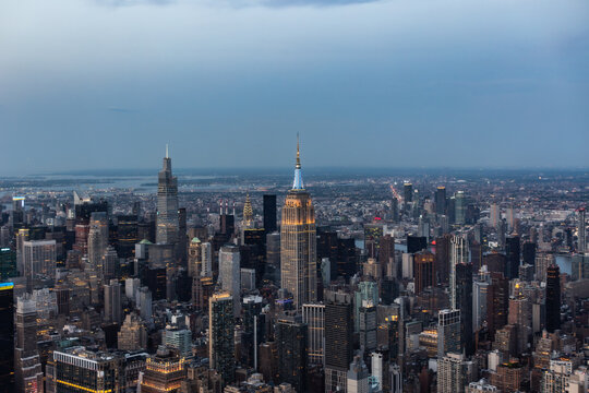 Aerial Image of New York City and Manhattan Panoramic Skyline with Iconic Empire State Building. Helicopter View of the Cityscape from Above with Towering Tourist Attraction