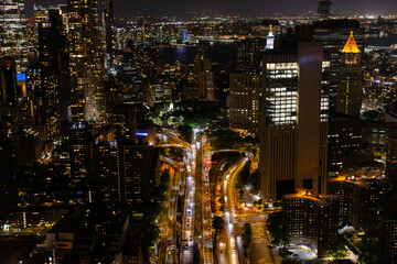 Aerial View of New York City. Helicopter Shot of a Busy Highway in New York City. Panoramic View with Traffic Commuting in Big City with Skyscrapers in the Background