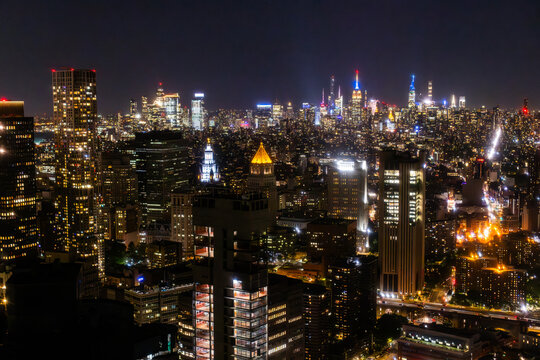 Scenic Aerial New York City View of Downtown Manhattan Architecture. Panoramic Photo of the Business District from a Helicopter. Cityscape with Buildings with Lights in Offices at Night
