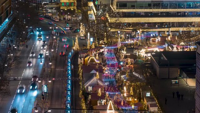 Time lapse view of the illuminated Christmas Market at the Breidscheidplatz in Berlib, Germany, during winter evening time