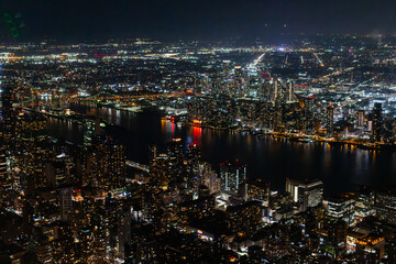 Night Aerial Photo with New York City Skyscrapers with Lights in Office Rooms Inside. Helicopter View View Capturing Panorama of Manhattan