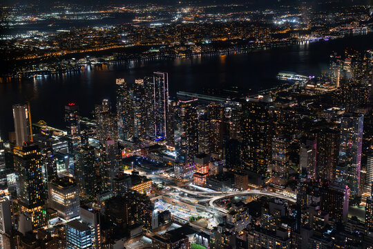Aerial View of Manhattan Architecture at Night. Night Photo of Financial Business District from a Helicopter. Scenery of Historic Office Towers, Illuminated Skyscrapers © Gorodenkoff
