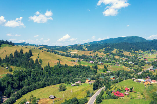 Aerial view of the mountains and village in the valley in spring. Beautiful nature landscape. Carpathian mountains. Ukraine © vvvita