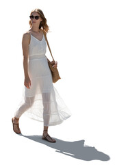 Woman in a white summer dress walking in backlight with wind blowing her hair, isolated on white...
