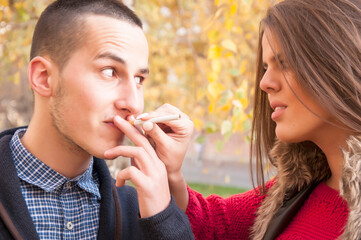 Attractive young woman trying to convince her boyfriend to quit smoking. Please leave that garbage. Healthy life concept.