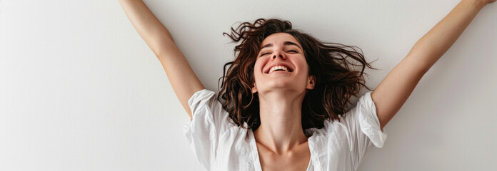 Exuberant Woman with Arms Raised and Curly Hair in White Shirt Feeling Free
