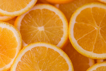 oranges cut into slices and laid out on the table as a food background 13
