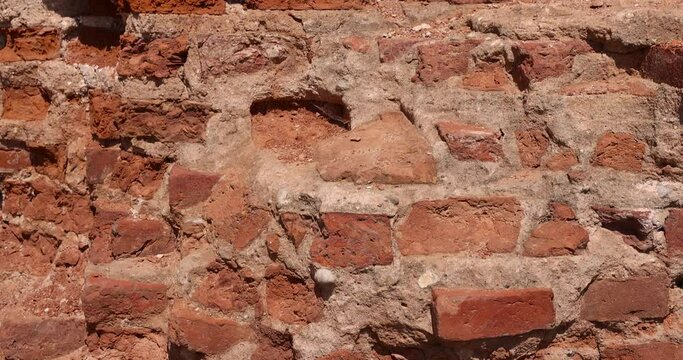 red brick ruins , damaged red bricks from the wall of an ancient building