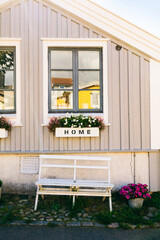 Home sign on window sill, rustic wooden house in Scandinavian style in Karlskrona Sweden
