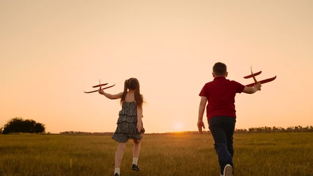 happy boy girl child play airplane pilot sunset, children family dream flying, kids playing laughing, parents children walking field, moment childhood, jumping, let your imagination take off, chasing