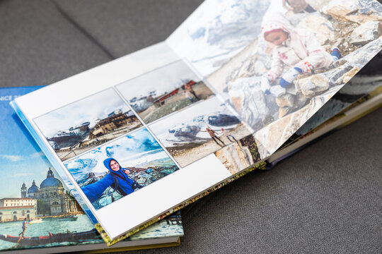 a Photobook of family at home on a background. Photobook is gift. professional photographer and designer. printing of photos and journals in photo laboratory