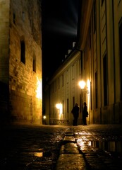 Alley illuminated by street lamps in Prague
