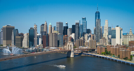 Aerial Cinematic Drone Scene Near  Brooklyn Bridge with New York Skyscrapers Cityscape. Beautiful Sun Shining on a Warm Summer Day. Photo of Historic Architecture