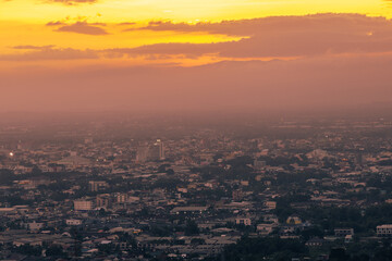 Naklejka premium The high angle background of the city view with the secret light of the evening, blurring of night lights, showing the distribution of condominiums, dense homes in the capital community