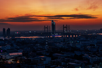 The high angle background of the city view with the secret light of the evening, blurring of night lights, showing the distribution of condominiums, dense homes in the capital community