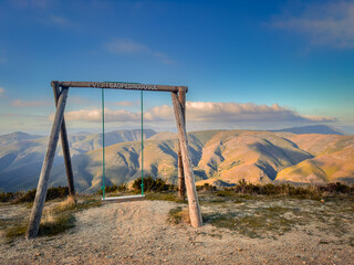 Wooden swing at Sao Pedro do Sul, with a beautiful view of Serra da Arada, in the center of Portugal.