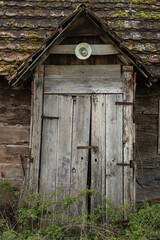 Fototapeta na wymiar Sunja , Croatia, 05,04,2021: Old wooden rustic door on rural home wall.
