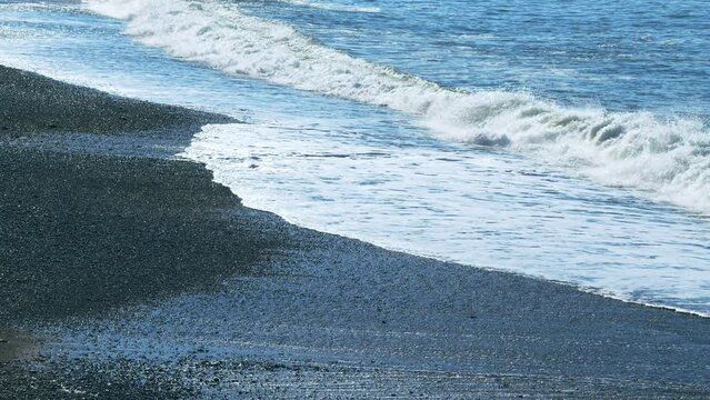 Pebble Beach And Sea Waves. Waves Washing The Pebble Beach. Calm Sea Surface. Slow motion.