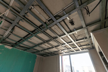 The metal frame of the ceiling, sound insulation, in the process of repairing an apartment - obrazy, fototapety, plakaty