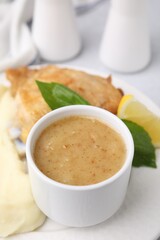 Delicious turkey gravy served on table, closeup