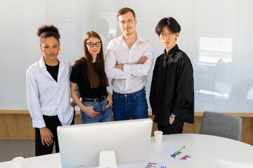 Close-up photo of a multinational team in the office.