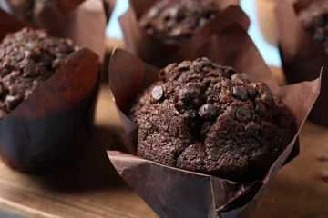 Tuinposter Tasty chocolate muffins on wooden board, closeup © New Africa