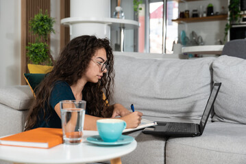 Young sick schoolgirl or student girl doing online homework or educational exam for college, using...
