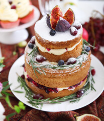 Dessert table for a wedding. Cake, cupcakes, sweetness, fruits and flowers