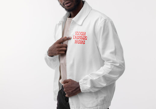 Mockup of man wearing customizable jacket pointing at logo