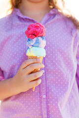 Girl holding ice cream cone in her hands