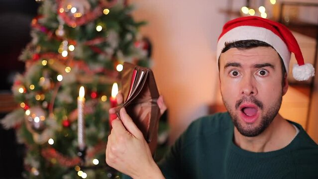 Man discovering an empty wallet after the Christmas holidays consumerism 