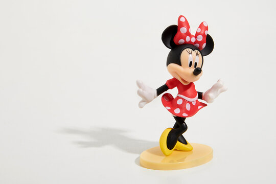 Colorful toy figure of cute Minnie Mouse in white studio