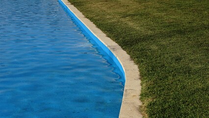 swimming pool and grass area as background