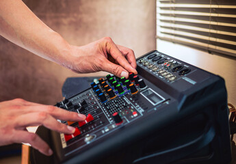 Sound engineer hands adjusting control sound mixer in recording, broadcasting studio,Sound mixer. Professional audio mixing console, buttons, faders and sliders. sound check.
