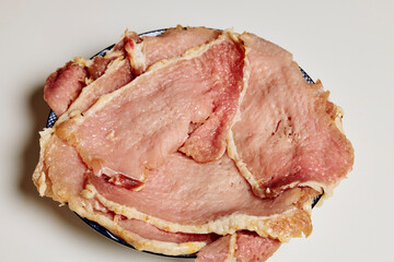 Pork tenderloin thinly sliced and prepared for schnitzel before cooking.