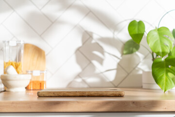 Kitchen background with cutting board, utencils, groceries, direct sunlight, shadows from trees