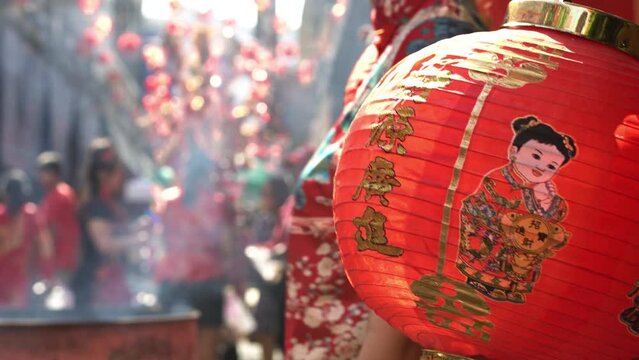 Chinese new year lantern in chinatown area. Translate chinese alphabet " ci yun gu?ng jn" on Lantern meaning Prosperous financial . Cheongsam or qipao concept