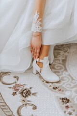 close up view of woman putting on shoes. The bride puts on her shoes before the wedding ceremony....